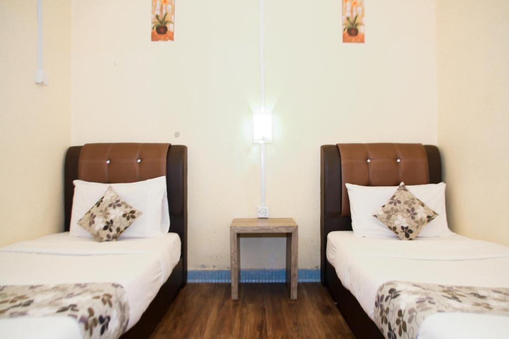 Postel nebo postele na pokoji v ubytování Myra Hotel Mersing
