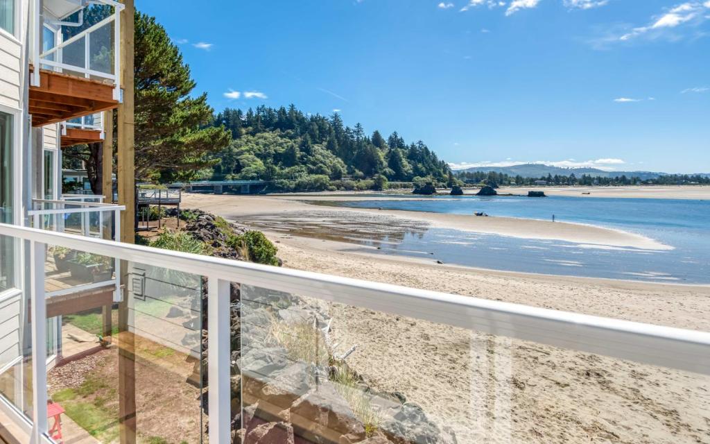 a view of the beach from the balcony of a house at Dock of The Bay #203 in Lincoln City