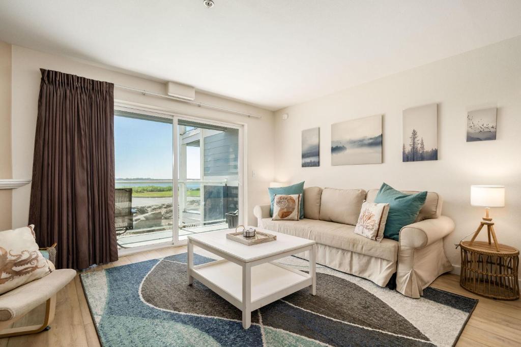 a living room with a couch and a table at Waters Edge 103 in Lincoln City