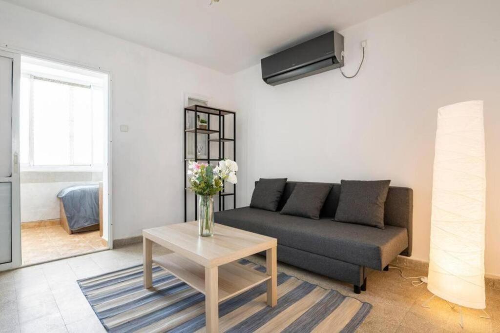 a living room with a couch and a table at "One minute from sea" from Shneider Apartments in Haifa