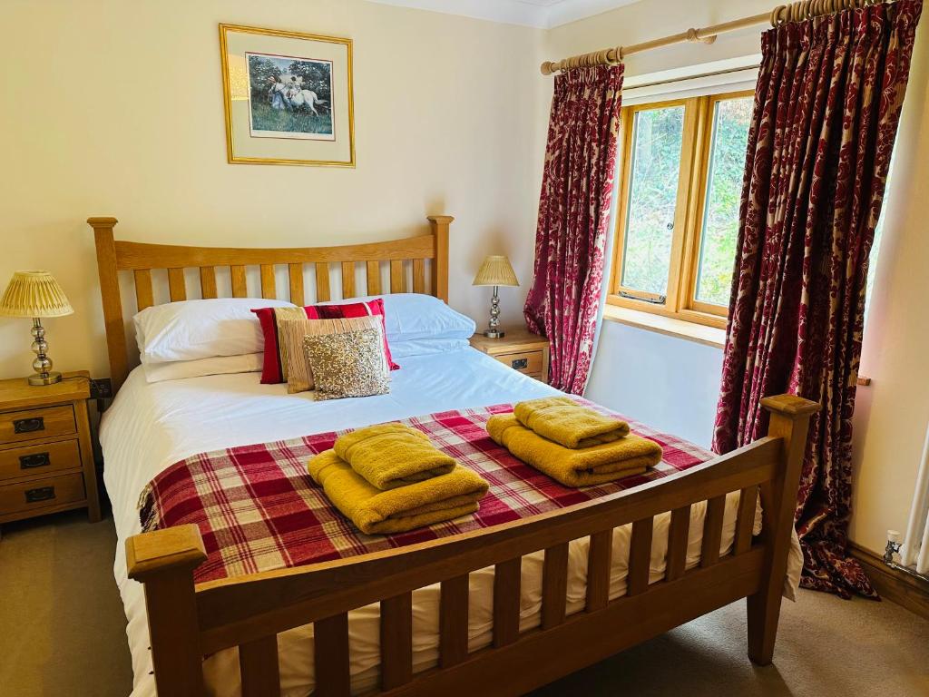 a bedroom with a bed with yellow towels on it at Poet's Cottage, Steep - Rural Location - Sleeps 6 in Steep