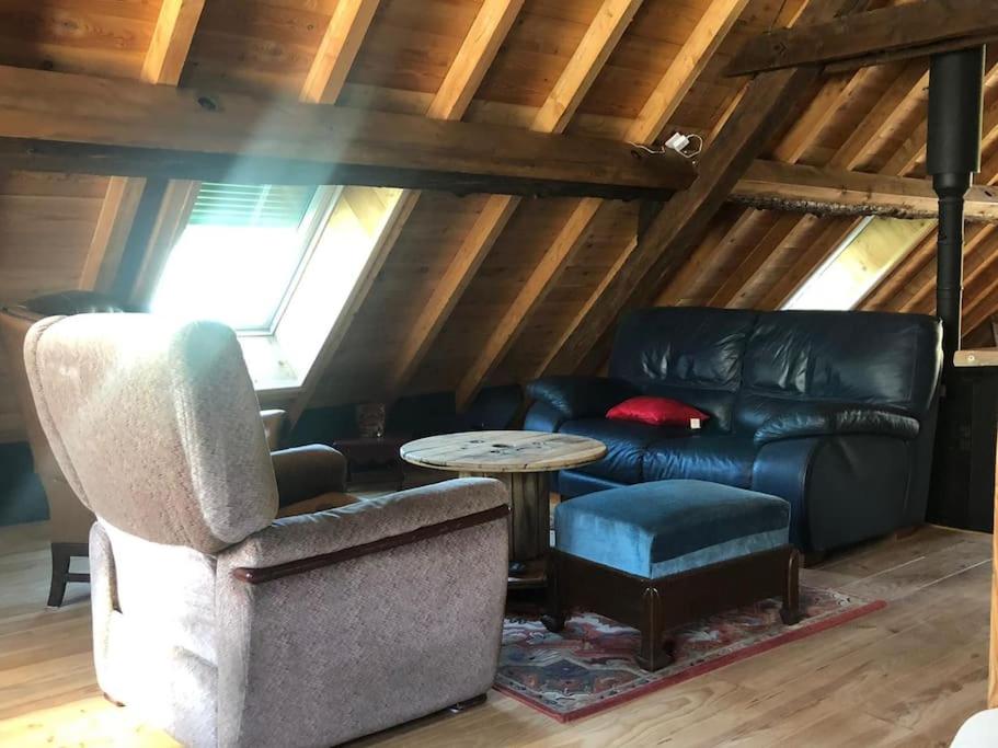 a living room with a couch and a table at Chez Pierrette et Eugène Prix nuitée&#47;10 personne in Le Lautaret