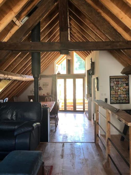 a living room with a couch and a large window at Chez Pierrette et Eugène Prix nuitée&#47;10 personne in Le Lautaret