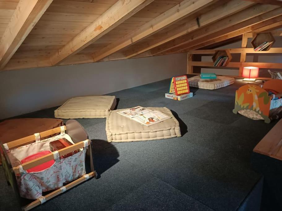 a attic room with three beds and a table at Chez Pierrette et Eugène Prix nuitée&#47;10 personne in Le Lautaret