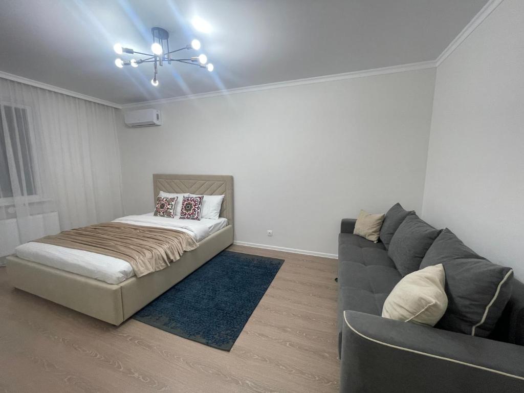 Postel nebo postele na pokoji v ubytování Жк Сезим кала бахыт