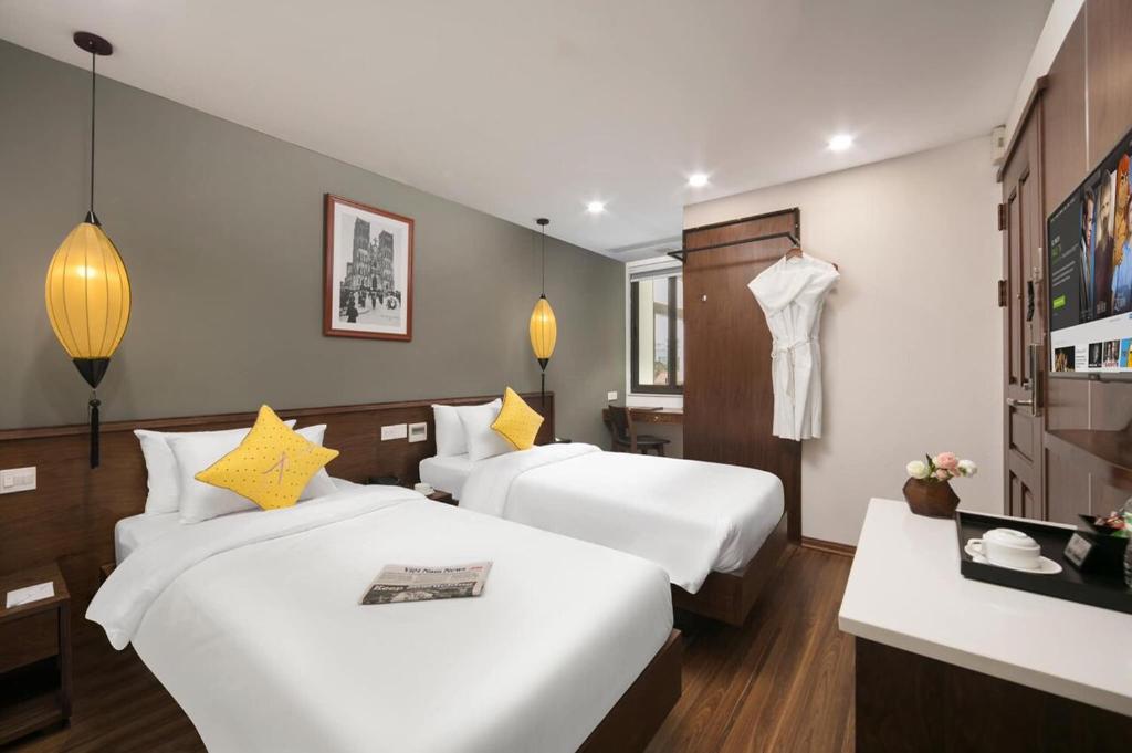Postel nebo postele na pokoji v ubytování Hanoi Exclusive Hotel