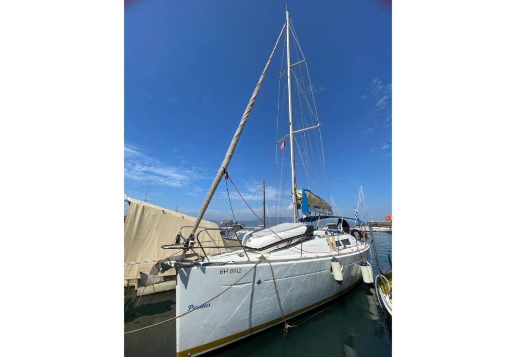 a sailboat docked at a dock in the water at S Odyssey 64051id in Corfu Town