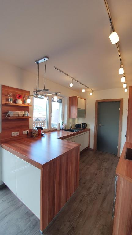 a kitchen with a wooden counter top in a room at Ferienwohnung am Mondsee in Mondsee