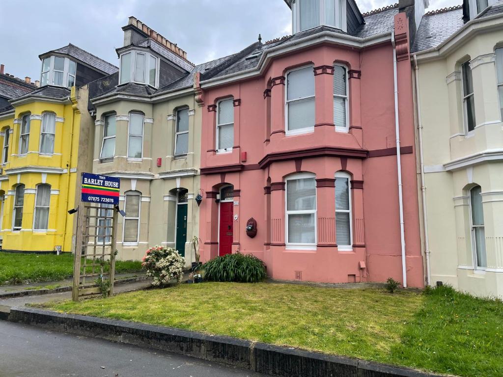 a pink house on the side of a street at OYO The Barley House in Plymouth