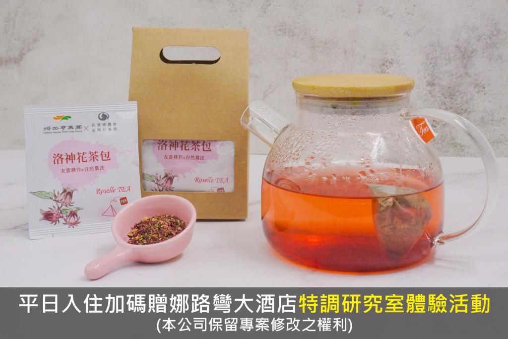 a jar of tea with a spoon and a packet of spices at Formosan Naruwan Hotel in Taitung City