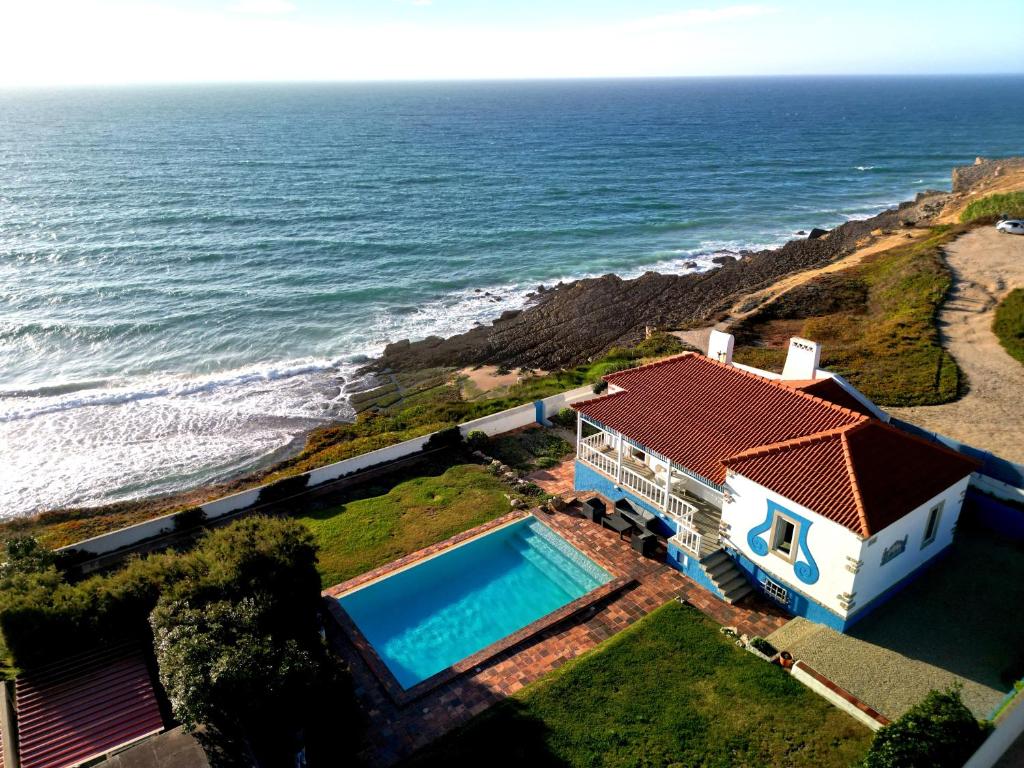 an aerial view of a house and the ocean at Villa Tamar - Azenhas do Mar in Azenhas do Mar
