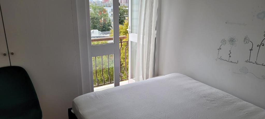 a bedroom with a bed and a window with a view at Comfy Room near Metro & Airport in Lisbon