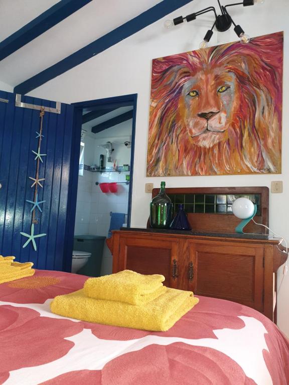 un dormitorio con una pintura de un león en la pared en Sondela Self Catering, en São Martinho do Porto