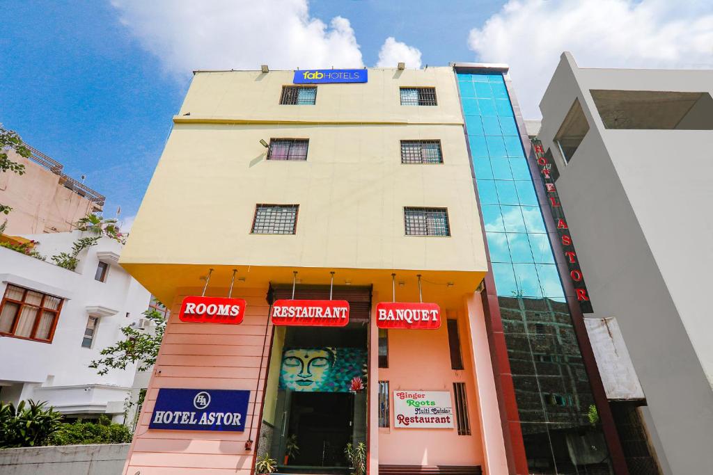 a tall building with a store in front of it at FabHotel Astor in Gaya