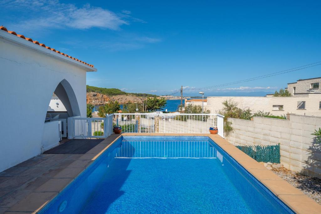 a swimming pool in the backyard of a house at Villa Sharon in L'Escala