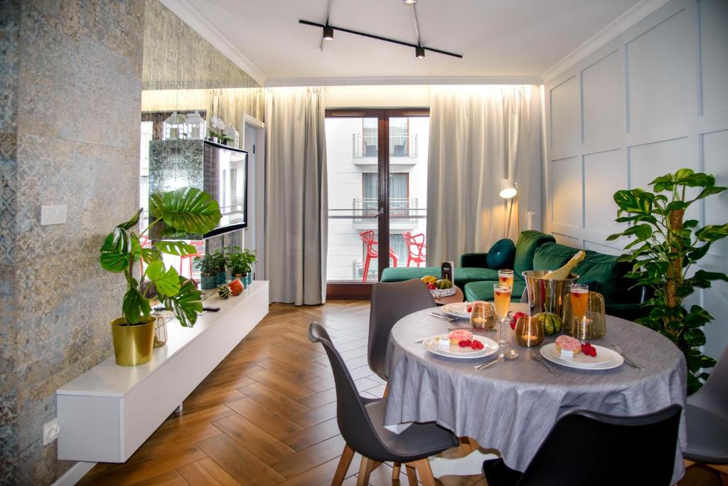 a living room with a table and chairs at Maya's Flats & Resorts 34 - Chmielna 73 in Gdańsk