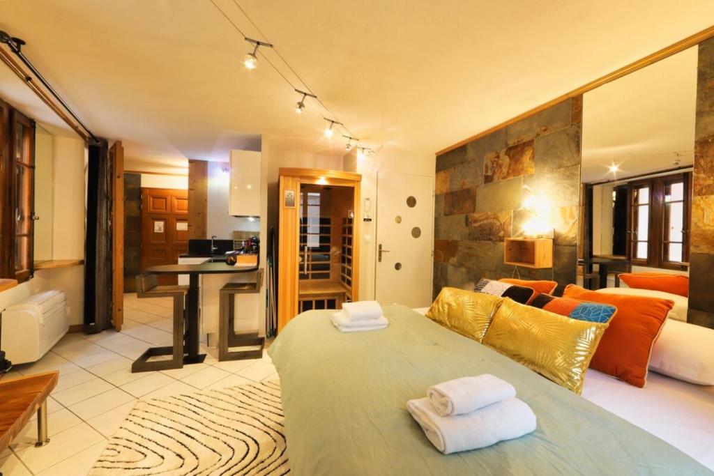 a bedroom with a bed and a living room at Le Cocon - Lofts & Lakes certified 4-stars in Annecy