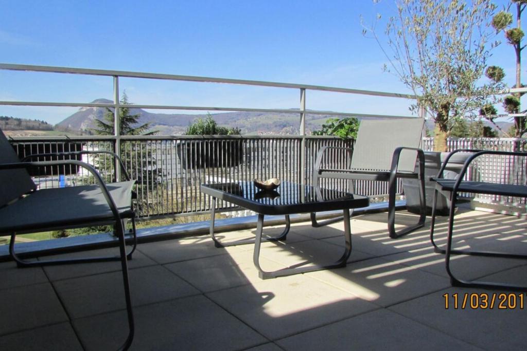 d'une terrasse avec 2 chaises et une table avec un chat. dans l'établissement Home on the roof w calm and tranquility, à Meythet