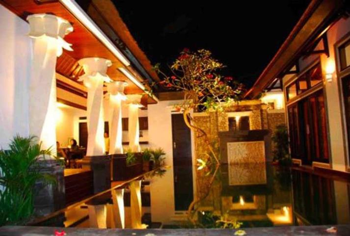 a house with a lit up porch at night at Villa Cantik Tresna in Seminyak