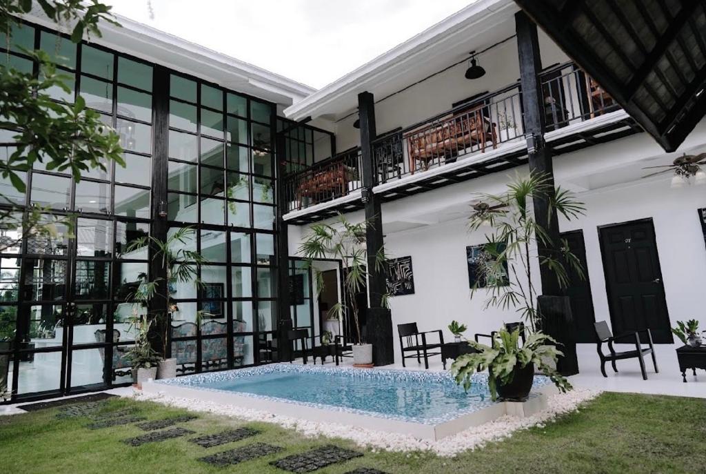 a building with a swimming pool in front of it at The Courtyard Chiangrai in Chiang Rai