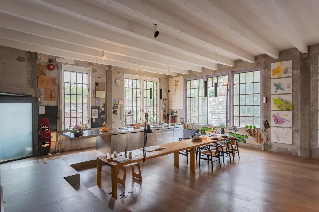 a large room with a table and some chairs at Design Loft with Private Parking by Rent All Como in Como