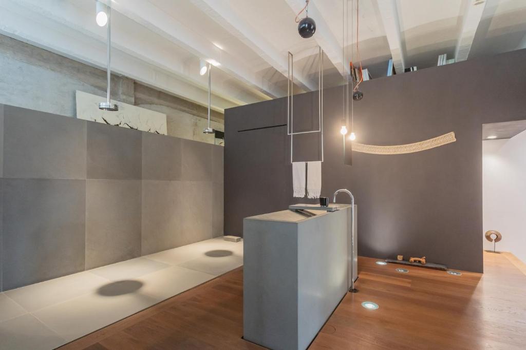 a room with a refrigerator in the middle of a room at Design Loft with Private Parking by Rent All Como in Como