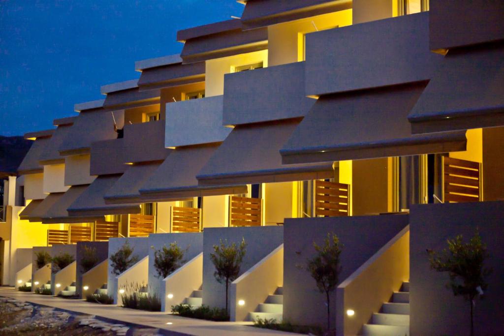 a building with a row of windows at night at Xanthippi Hotel in Souvala