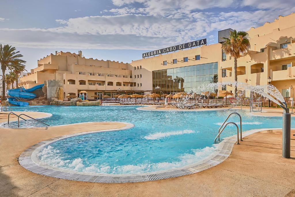 a large swimming pool in front of a hotel at ALEGRIA Cabo De Gata in Retamar