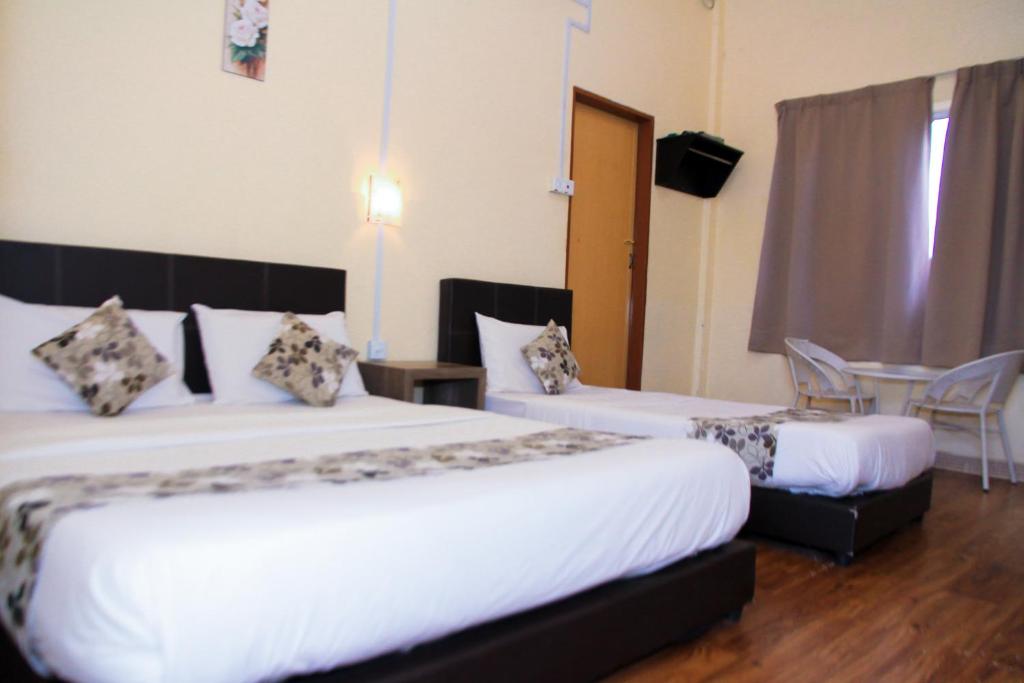Postel nebo postele na pokoji v ubytování Myra Hotel Mersing