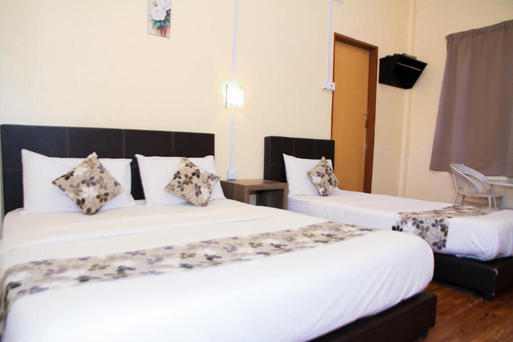 Postel nebo postele na pokoji v ubytování Myra Hotel Mersing