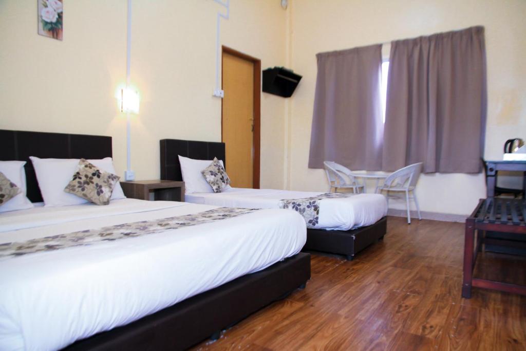 Postel nebo postele na pokoji v ubytování Myra Hotel Mersing
