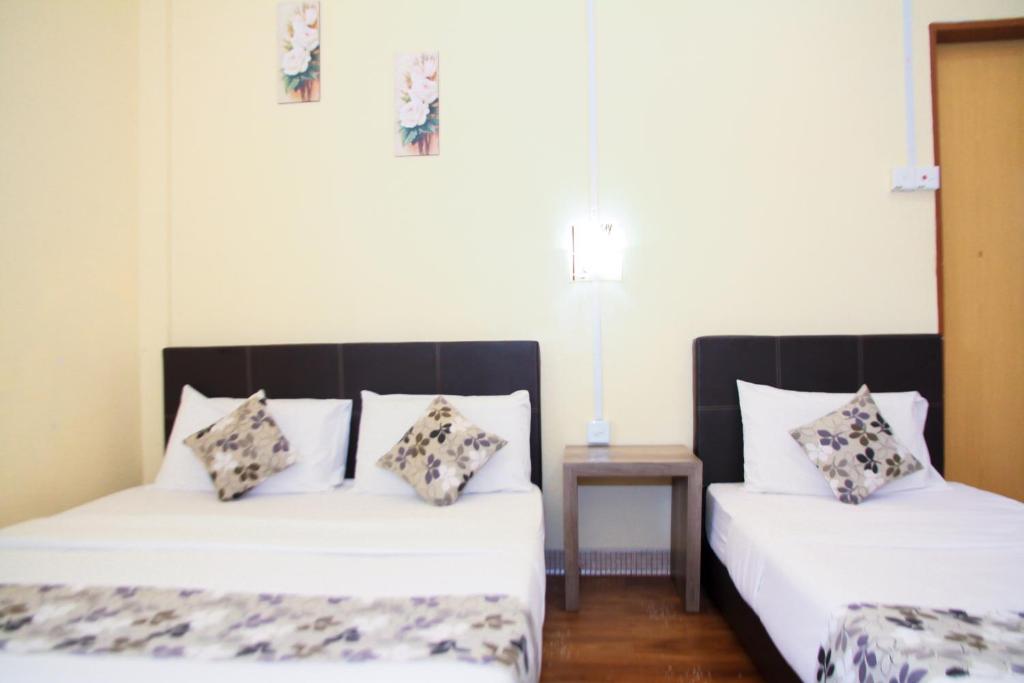 Postel nebo postele na pokoji v ubytování Myra Hotel Mersing
