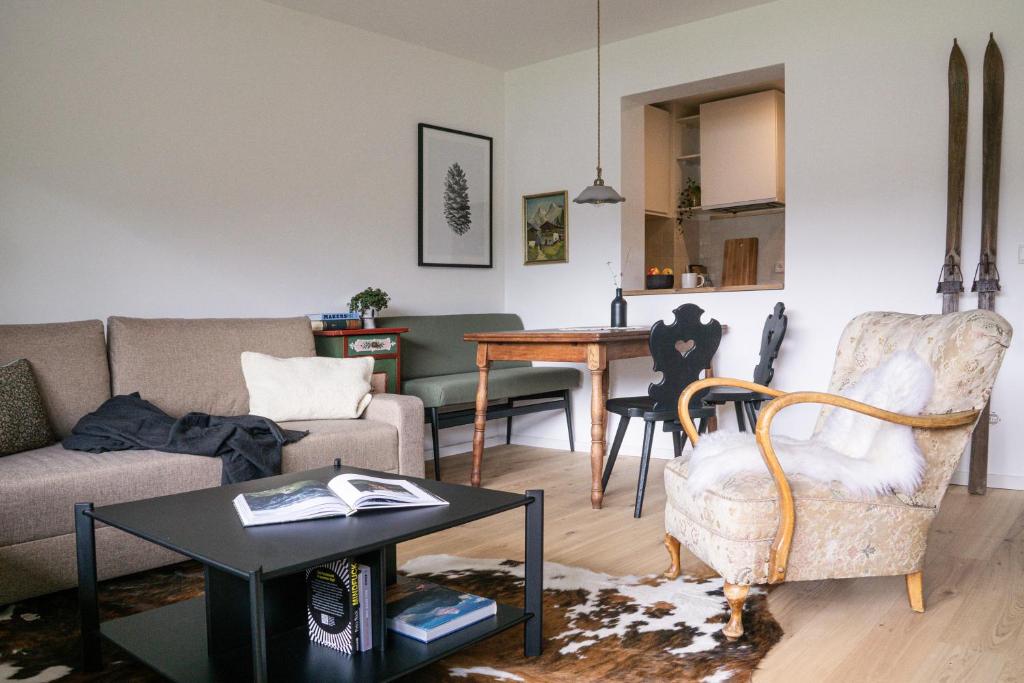 ein Wohnzimmer mit einem Sofa und einem Tisch in der Unterkunft Servus O´gau Apartments in Oberammergau