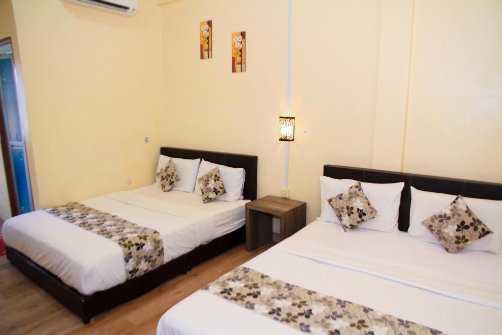 Postel nebo postele na pokoji v ubytování Myra Hotel Mersing