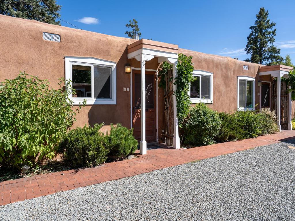 a house with a brick driveway in front of it at Rio Vista Casita in Santa Fe