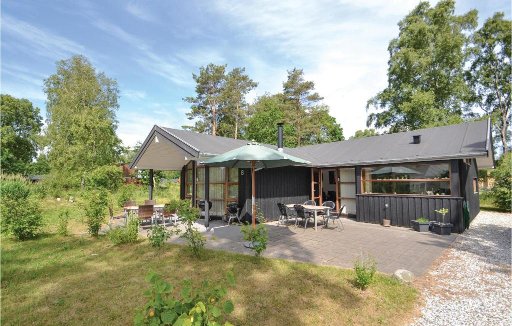a house with a deck and a patio at Pet Friendly Home In Grenaa With Kitchen in Grenå