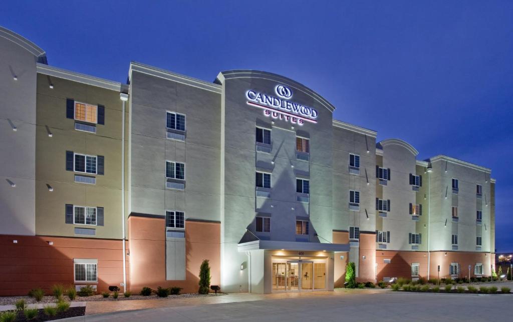 a rendering of the granlund hotel at night at Candlewood Suites Kansas City Northeast, an IHG Hotel in Kansas City