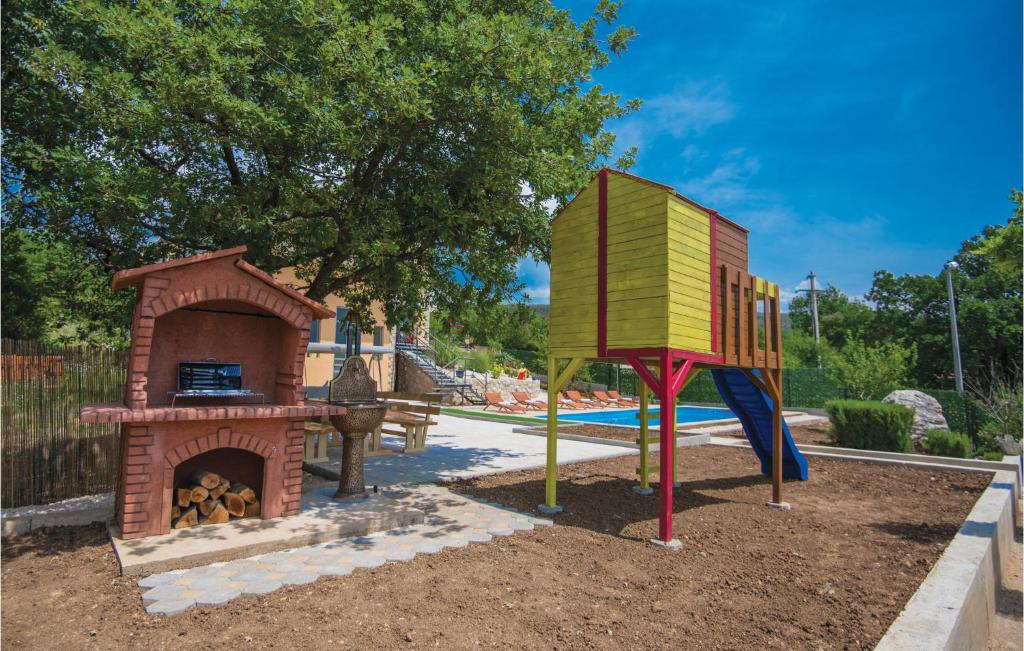 a playground with a play structure and a pizza oven at Stunning Home In Vinjani Donji With 5 Bedrooms, Wifi And Outdoor Swimming Pool in Majići