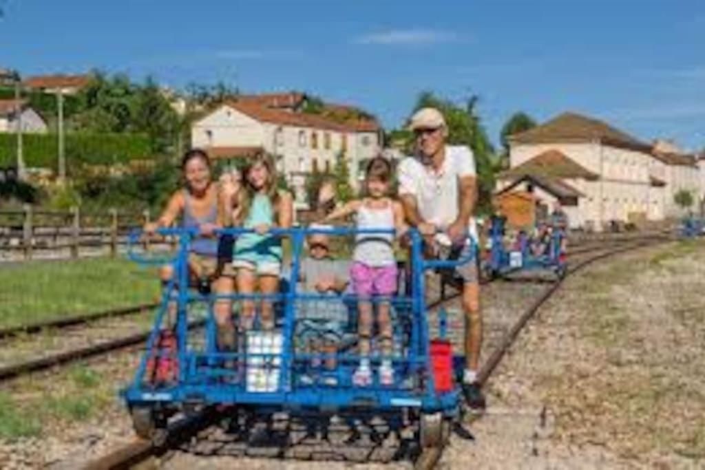 a group of people riding on a toy train at Au pool house de la Faye avec jacuzzi in Saint-Romain-Lachalm