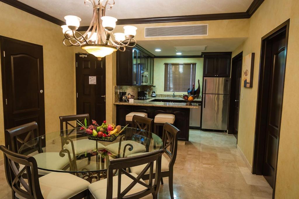 a dining room and kitchen with a glass table and chairs at Enticing Huge Unit at Cancun Resort Strip Las Vegas in Las Vegas