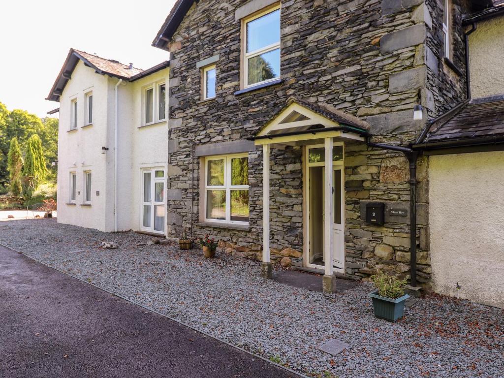 a stone house with a driveway in front of it at Silver How in Ambleside