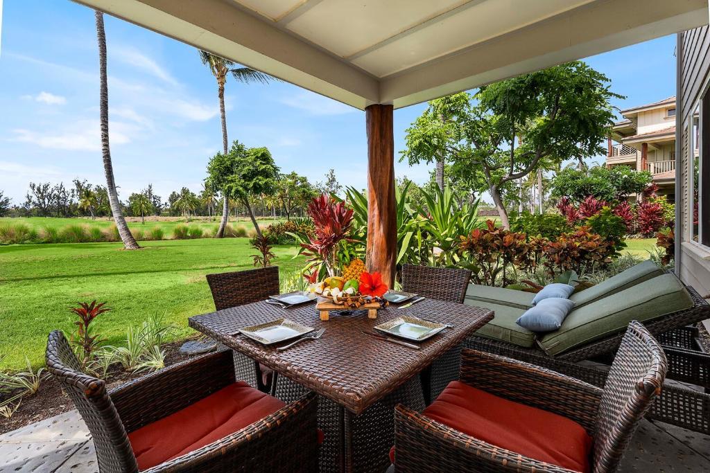 a patio with a table and chairs on a porch at Waikoloa Beach Villas L3 in Waikoloa