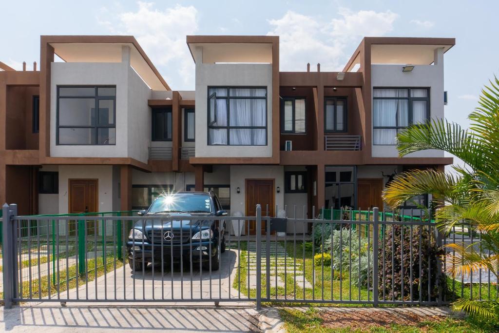 a house with a car parked in front of it at Urban oasis in kingsland city in Lusaka