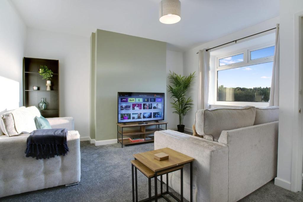 a living room with two couches and a tv at Sweet Home with Backyard in Howden-le-Wear for 3 in Crook