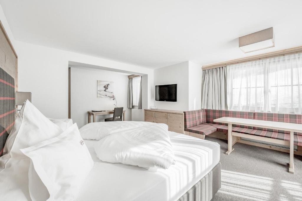 Postel nebo postele na pokoji v ubytování Hotel Jenewein