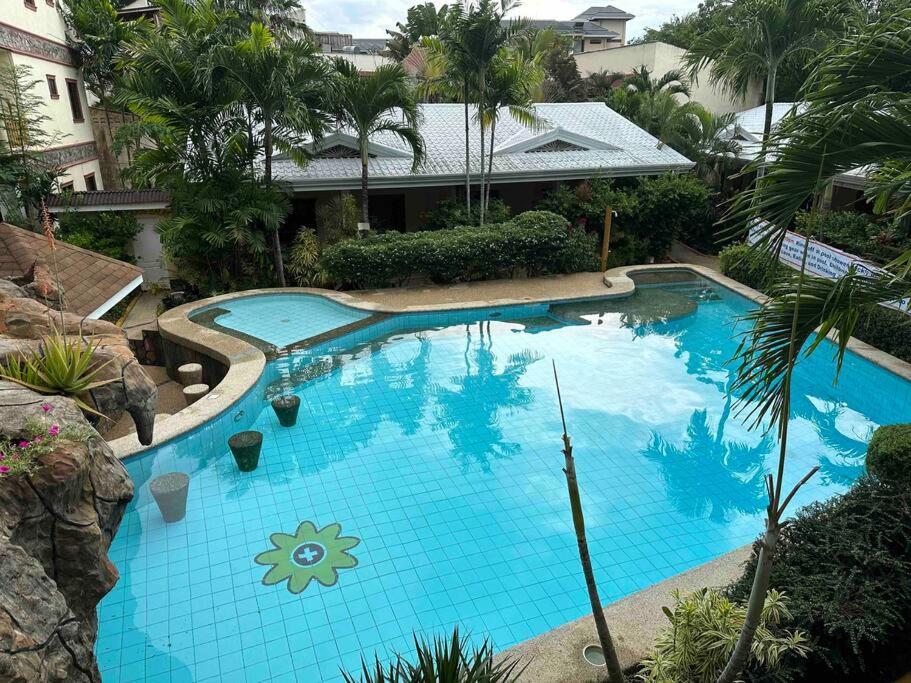 an overhead view of a large blue swimming pool at Alona Park Residence - 3 bedroom apartment- alex and jesa unit in Panglao