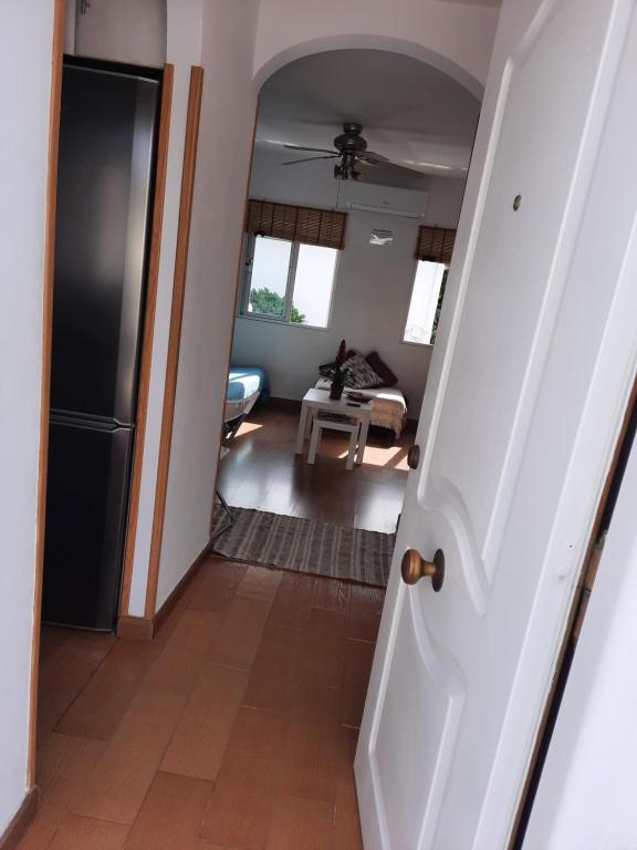 a hallway with a door leading to a living room at Apto a 2 minutos de playa. in Fuengirola