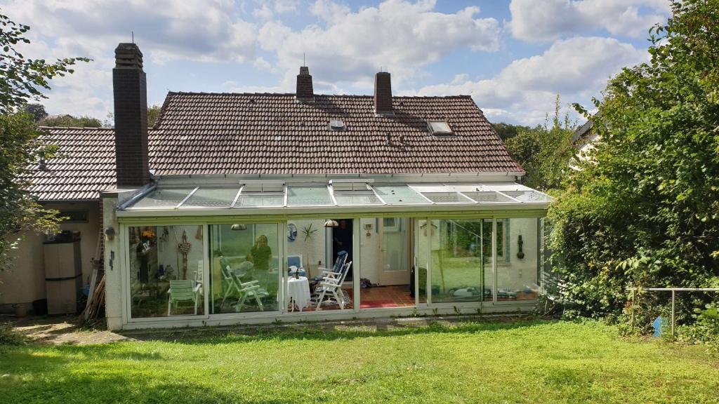 mały dom z oranżerią ze szklanymi drzwiami w obiekcie Ferienhaus mit großem Garten w mieście Bad Gandersheim