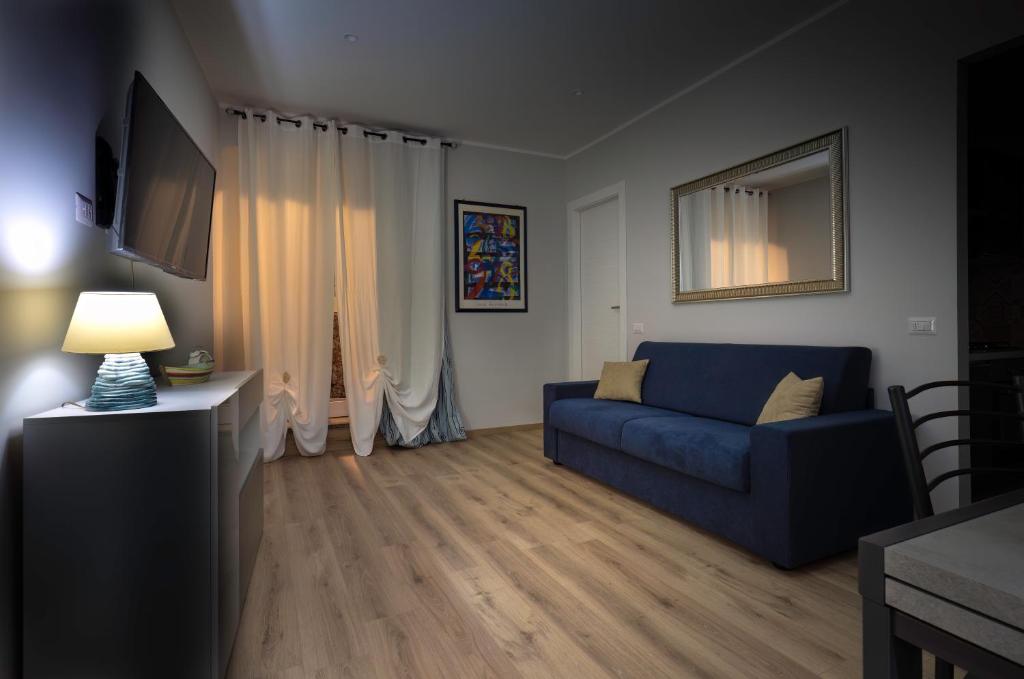 a living room with a blue couch and a television at Il Rosone - Rooms&Apartments in Alatri
