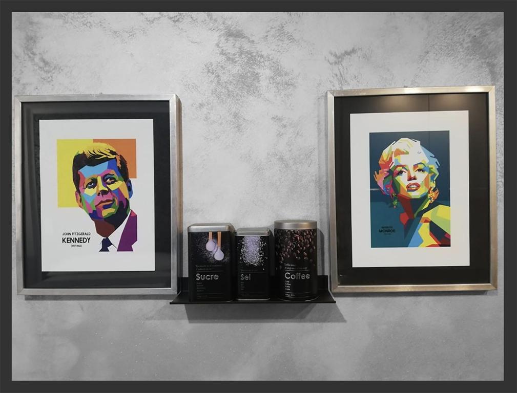 two framed pictures of a woman on a shelf at Grazioso Monolocale Acquario a 100m free WI-FI in Genova